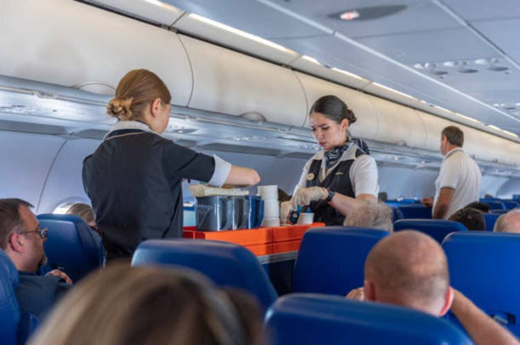 Aeroflot Russian Airlines Cabin Crew Serving Food and Beverages during the flight to Moscow from Rome, Italy.