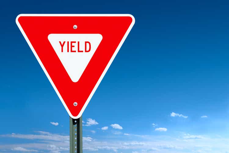 Yield road sign against a blue sky