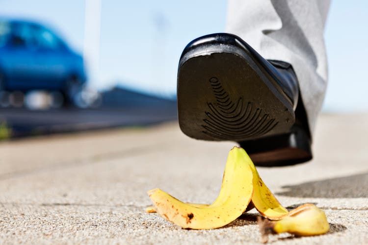 Painful slip coming as man"s foot approaches banana peel