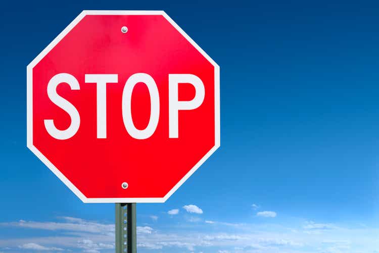Stop Sign Post Over a Blue Sky Background