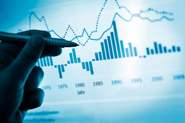 Hand pointing with pen on a computer chart / document