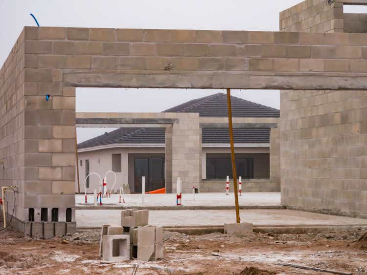 View through a house under construction of another house under construction