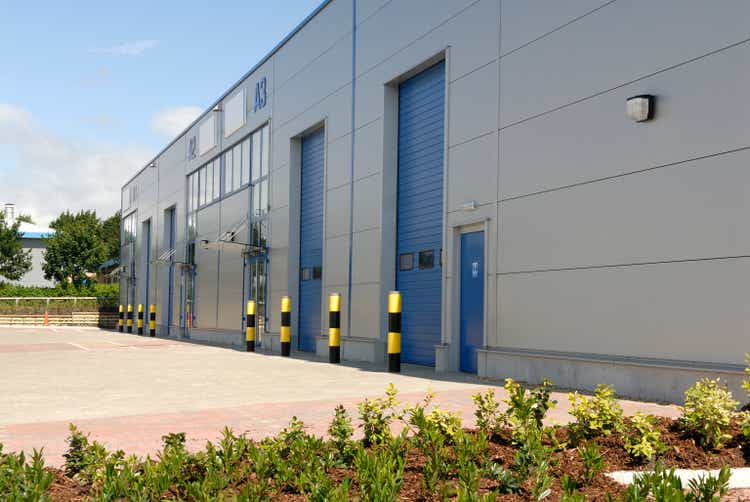 Outside of a big industrial warehouse unit with blue doors