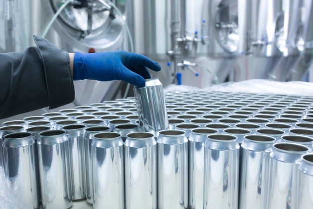 drink production manufactrure, worker"s hand taking new aluminium cans