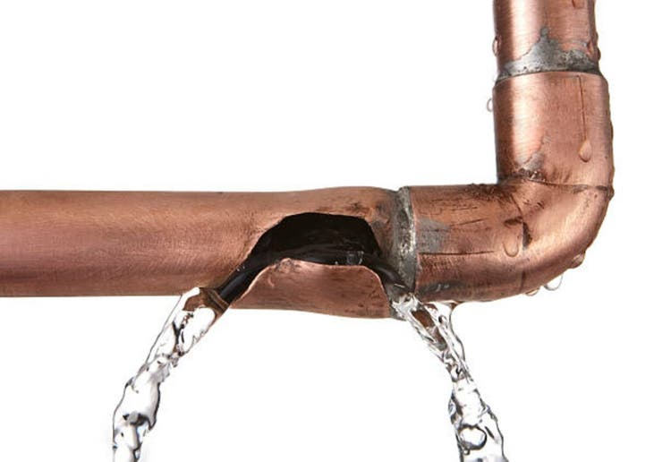 broken leaking copper water pipe