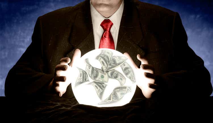 Businessman Consulting a Glowing Financial Crystal Ball