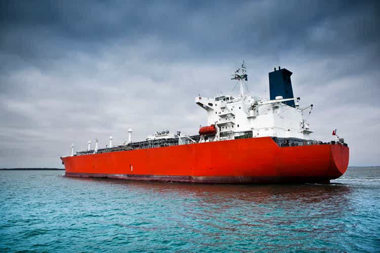 Red tanker ship afloat in the ocean