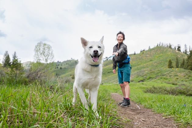 Young woman walking her dog on a leash