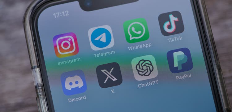 Mainz, Germany - August 02, 2023: iphone on a table showing icons of the apps instagram, telegram, tiktok, twitter, discord, telegram, chatgpt and paypal