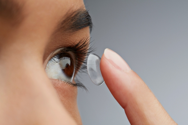Close-up of woman putting in contact lens
