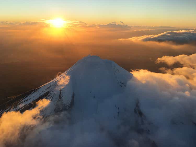 Magical sunrise over the snow-covered summit of Mt Taranaki in New Zealand
