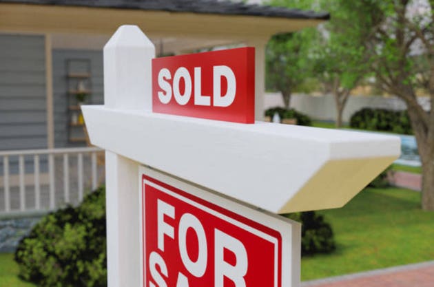 Sold For Sale Real Estate Sign In Front of House.
