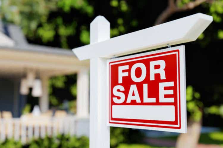 For Sale Real Estate Sign In Front of House.
