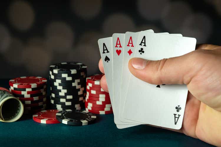 Poker cards with a four of a kind or quads combination in the player hand. Winning combination in a game in a poker club. The concept of luck in the poker game