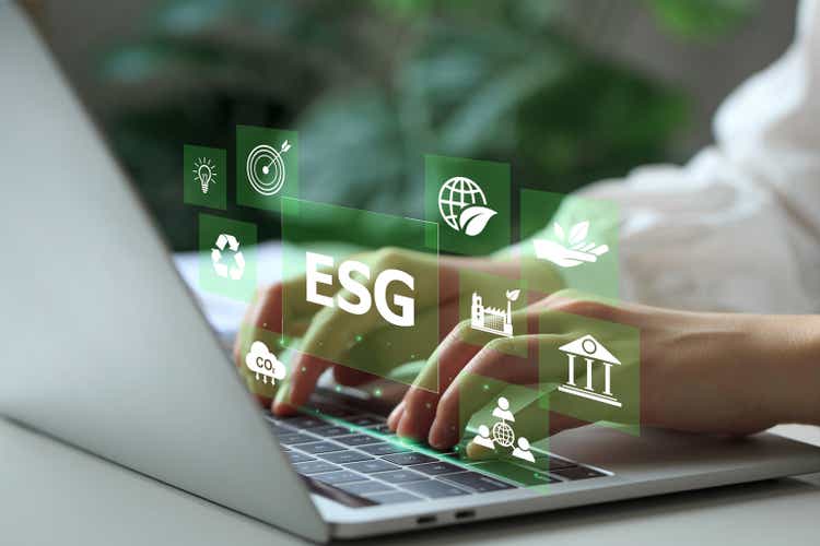 ESG environmental social governance investment business concept. Woman working on laptop computers with ESG icons surround. Concept of Investment strategy for Business and environmental sustainability