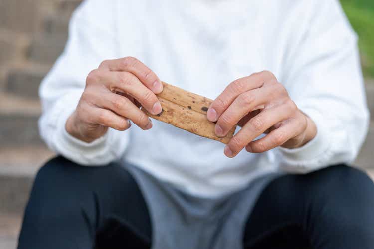 Close up of two hands holding a protein bar