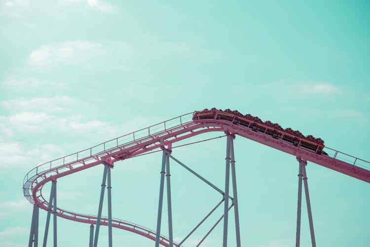 Pink pastel looping rollercoaster in amusement park.