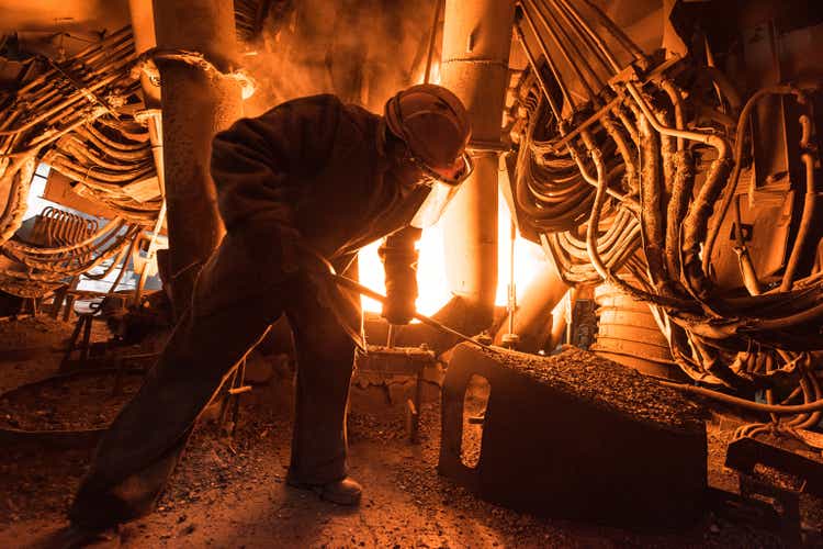 Steelworker at work near the arc furnace