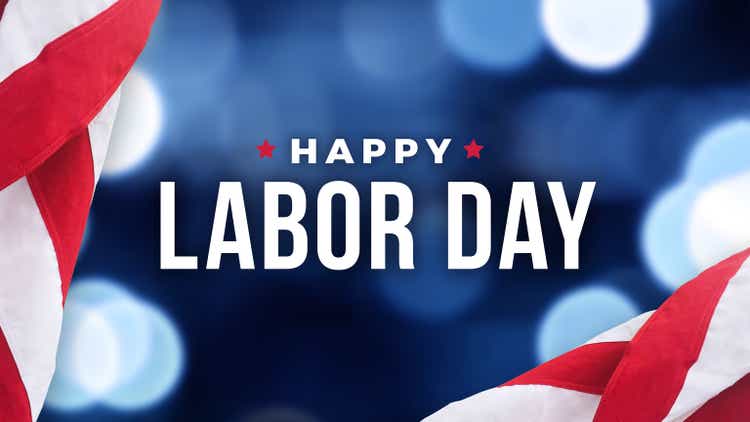 Happy Labor Day Holiday Text with Blue Bokeh Lights Background and Patriotic American Flags