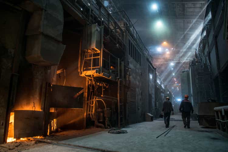 Steel workers at the working arc furnace