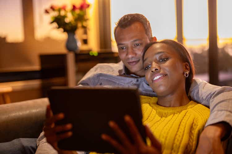 Couple watching a movie together on their sofa