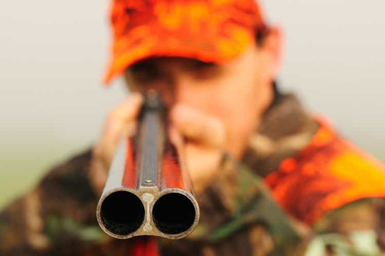 Close up of a hunter aiming his shotgun