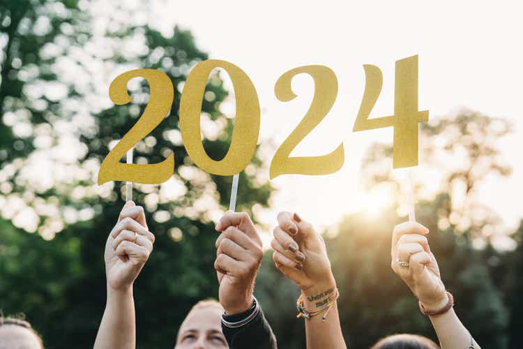 Friends are holding 2024 text to celebrate the New Year