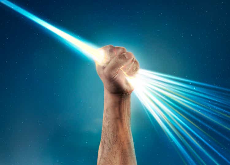 hand holding light laser beam that bursts out