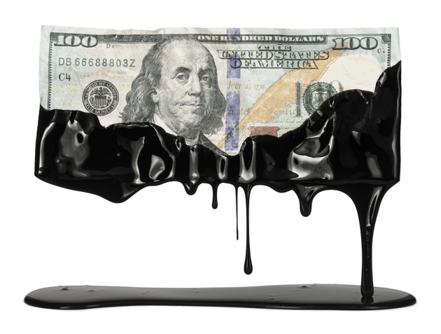 US American dollar bill dripping with crude oil showing the high cost of gas at the pump or the USA dependency on fossil fuels.