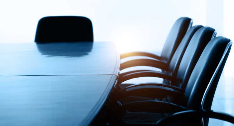 Conference table and chairs in empty meeting room