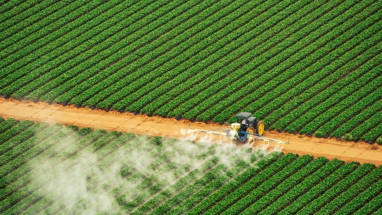 Tractor spraying fertilizer