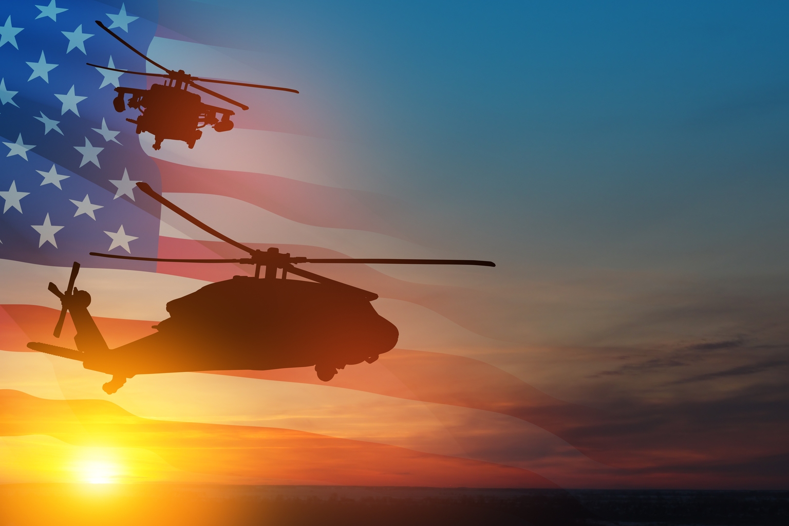 Silhouettes of helicopters on background of sunset with a transparent American flag.