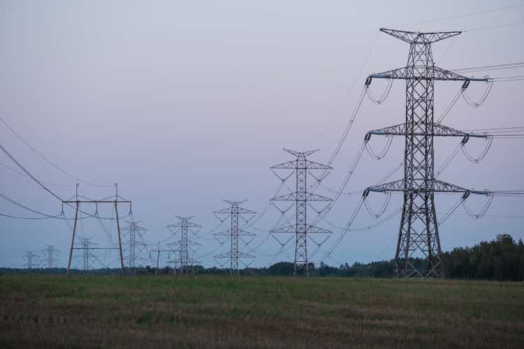 Tall electricity pylons. Powergrid, transmission tower and energy crisis.