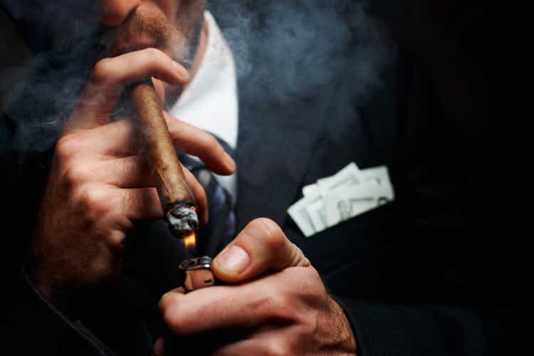 Close-up of man"s hand with cigar and lighter