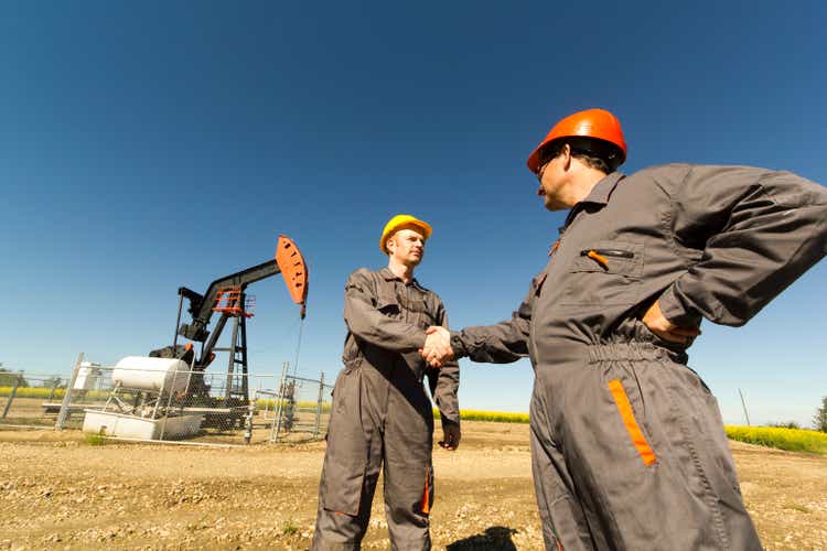 Oil Derrick Handshake