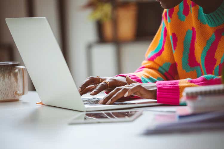 Woman typing on laptop keyboard