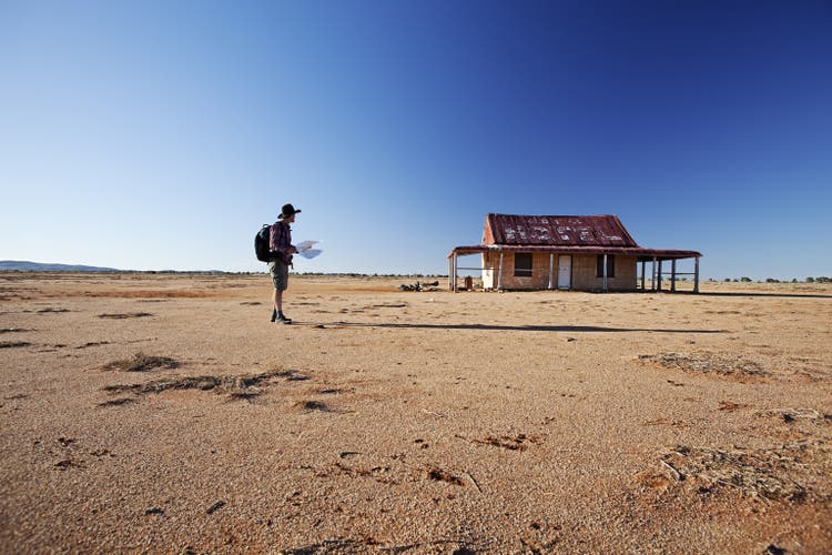man in front of outback shed