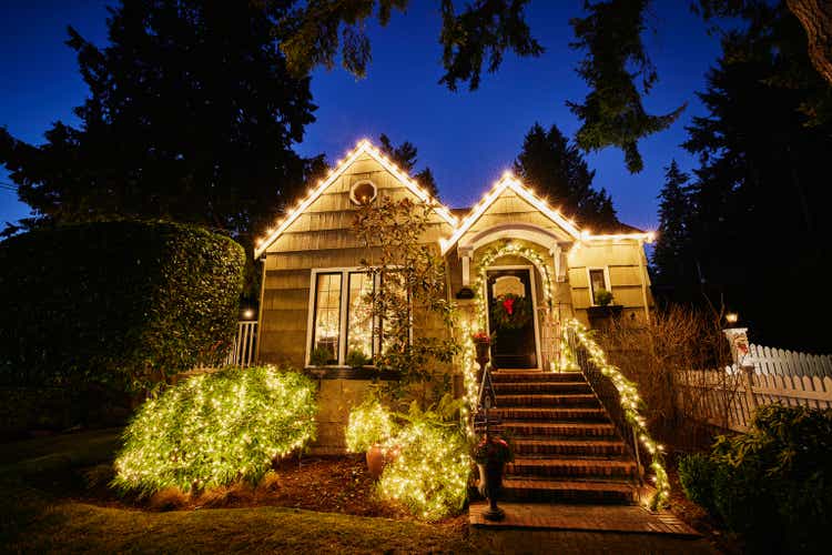 Wide shot of home decorated for Christmas on winter evening