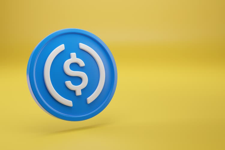 USDC coin on yellow background with copy space. 3d iluustration.