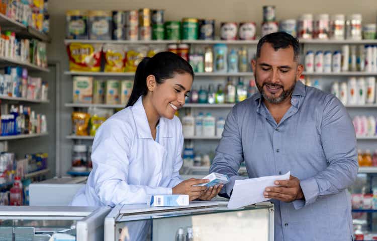 Man buying medicines at the pharmacy with a prescription