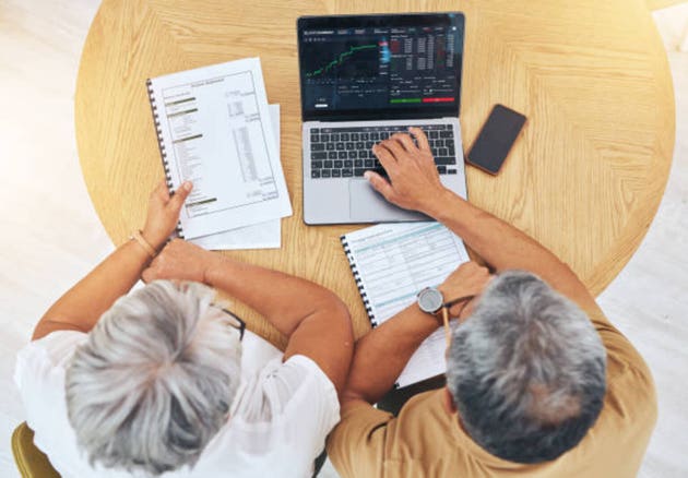 Couple, computer screen and data analysis, stock market graphs and budget, financial planning or asset management above. Senior people on laptop for trading, investment and accounting report or stats