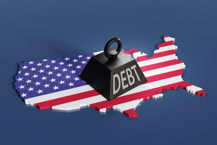 Black one ton weight marked with the word DEBT dropped on the national map of the USA. Illustration of the concept of rising American government debt