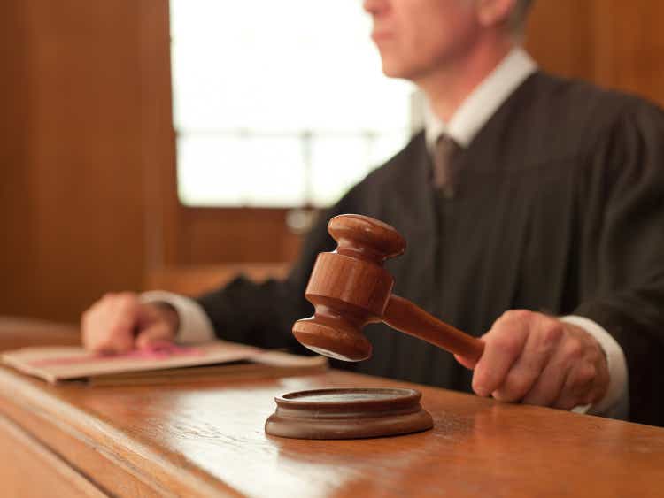 The judge holds the gavel in the courtroom