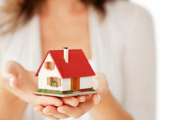 Woman"s Hands Holding a Little House - Isolated