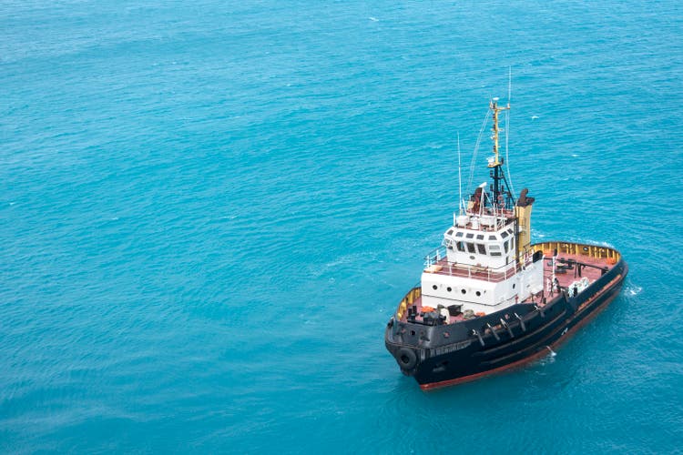 Tugboat In Tropical Blue Ocean Water