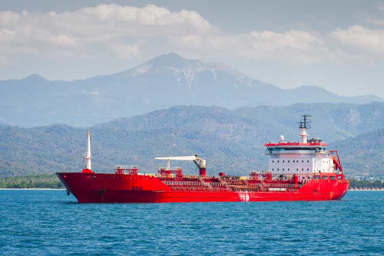 The red oil tanker transports petroleum products.