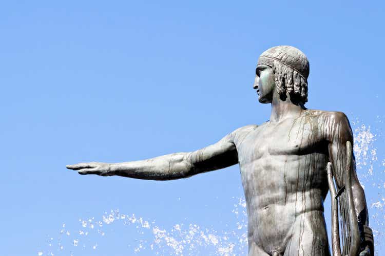 Statue of Apollo-god of music against blue sky, copy space