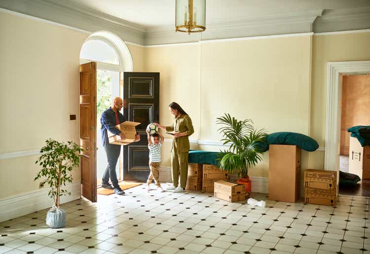 Family in hallway of new house on moving day