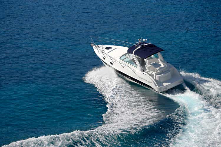 White motorboat making waves on blue water