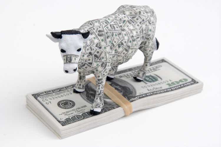 Cash Cow on pile of $ Money Bills